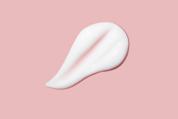 istock A dab of cosmetic cream. Light, smooth surface. Texture of spreadable cream. Liquid cream smear. On a pink background. 1485133629