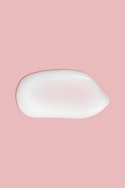 istock A dab of cosmetic cream. Light, smooth surface. Texture of spreadable cream. Liquid cream smear. On a pink background. 1485133746
