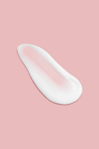 istock A dab of cosmetic cream. Light, smooth surface. Texture of spreadable cream. Liquid cream smear. On a pink background. 1485133782