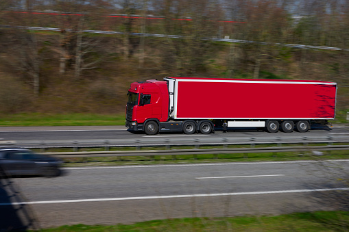 Truck passing through landscape with road