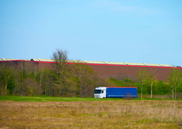 Truck passing by huge warehouse