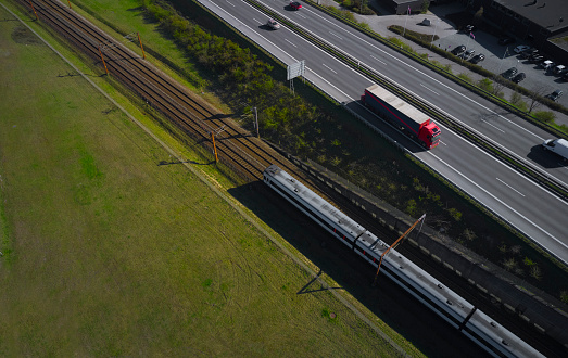 Train and red truck passing each other