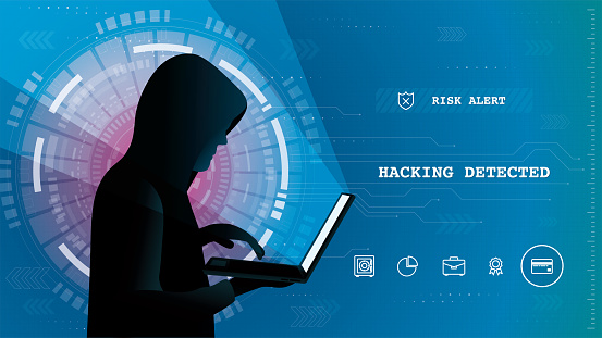 Side view of a young hacker using a laptop on a hacking electronic banking security breach background