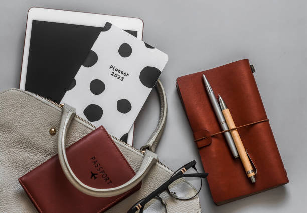istock Office women's business education background. Women's bag, tablet, planner, notepad on a gray background, top view 1485137910