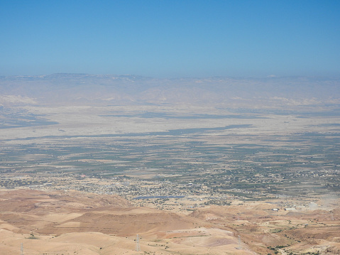View from Mount Nebo over the Jordan Valley and Palestine in the distance.  This image was taken on a sunny morning on 25 April 2023.