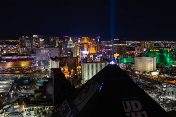Las Vegas Strip at Night Las Vegas, United States - November 24, 2022: A picture of the Las Vegas Strip at night, with the top of the pyramid of the Luxor Hotel and Casino on the bottom. las vegas pyramid stock pictures, royalty-free photos & images