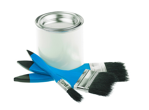 Generic white tin can with paint and a few flat brushes for painting walls, furniture or art. Isolated on white background