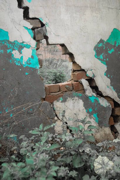 istock Cracked broken hole in concrete wall - stock photo 1485143562