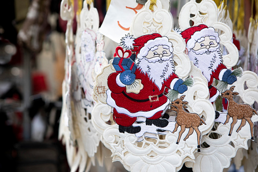 Traditional Christmas decorations featuring Father Christmas - hanging for sale outside a shop in Germany