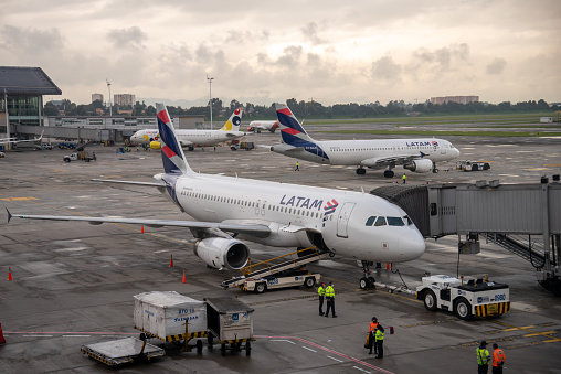 Latam airline planes and viva colombia in the background in the boarding area of El Dorado airport. Bogota. Colombia. July 8, 2022.
