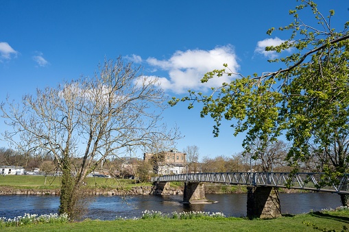 Footbridge over the river Cocker at Cockermouth, Cumbria, UK, in Springtime.