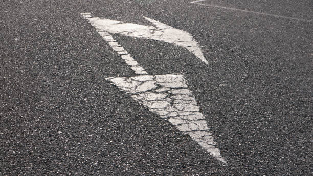 istock Road divider arrows sign in road 1485146469