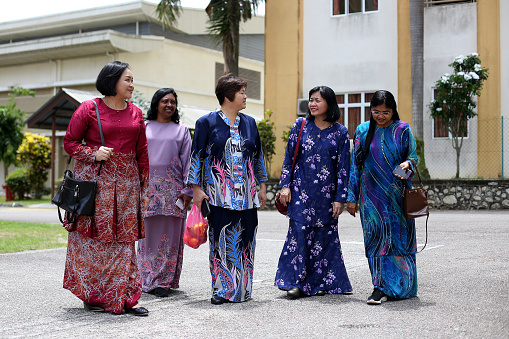 Asian women in traditional clothing walking together cheerfully