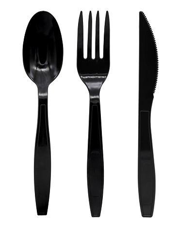 Black plastic spoon fork and knife isolated on white background