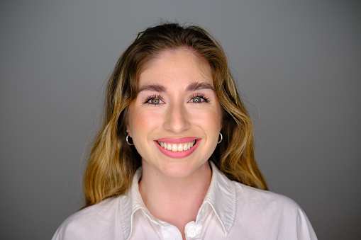 close-up shot portrait of a generation z woman in a gray background studio