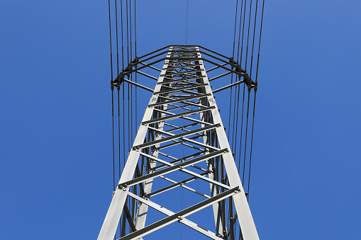 Electric high voltage power post with blue sky