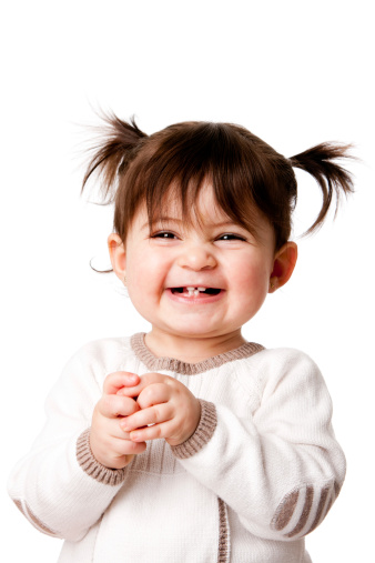 Beautiful expressive adorable happy cute laughing smiling baby infant toddler girl with ponytails showing teeth, isolated.