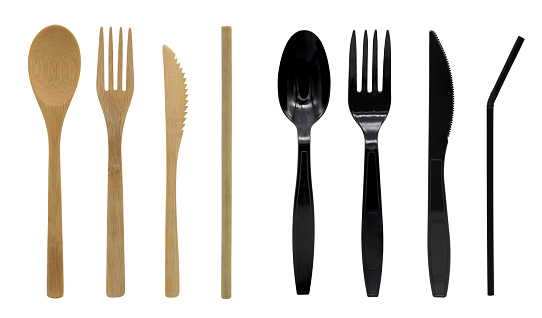 Cutlery of wood and plastic disposable spoon, fork, knife and straw. Isolated on white background.