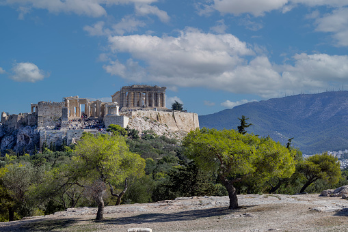 Athens, Greece - October 17, 2022: View of the Acropolis of Athens with Parthenon from Muse Hill on a background of blue sky