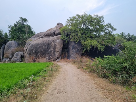 The road to the temple is surrounded by a huge rock