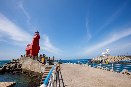 JEJU ISLAND, South Korea - 4 Apr 2023 : Wonderful Iho Tewoo Beach two horse shaped lighthouses. Jeju Island, South Korea