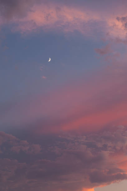 istock The orange pink sunset sky with a quarter moon. 1485163808