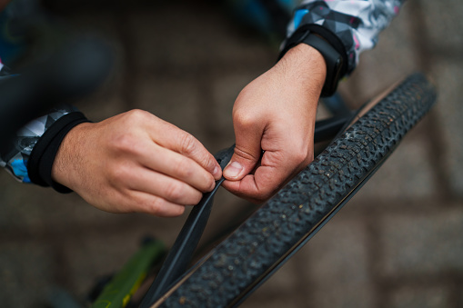 Man repairs the punctured bicycle tire