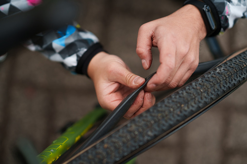 Man repairs the punctured bicycle tire