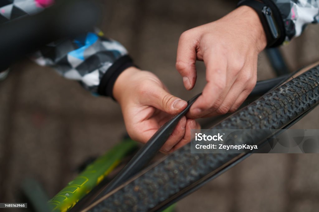 Man repairs the punctured bicycle tire Bicycle Stock Photo