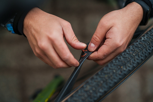 Man repairs the punctured bicycle tire