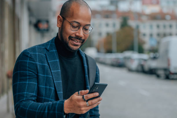 istock man looking at mobile phone in the street 1485165230