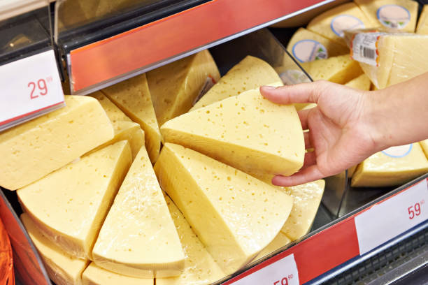 istock Hands with cheese in shop 1485166385