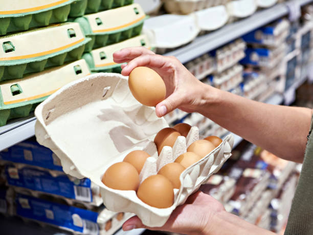 istock Woman with packing eggs in shop 1485167276