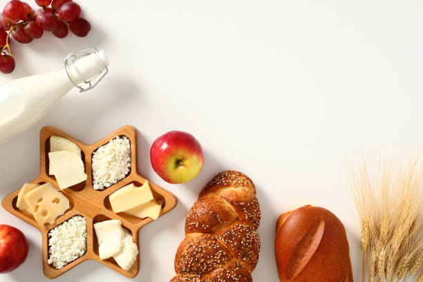 istock Happy Shavuot concept. Flat lay composition with dairy products, bread, wheat, cheese, bottle of milk, grape on white table. 1485168143