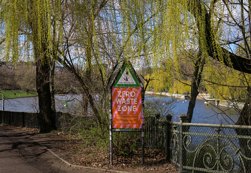 A sign indicating a Zero Waste Zone in Tiergarten Park, along the Spree River, in Berlin Germany.  Zero Waste is a concept to leave no net waste of any sort in the area.