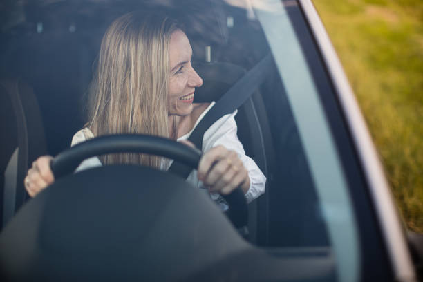 istock Pretty middle aged woman at the steering wheel 1485171729
