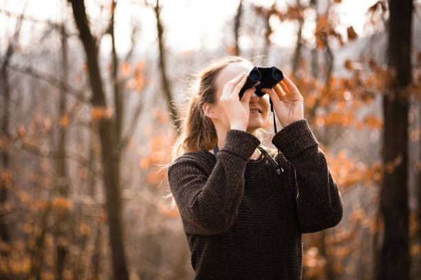 istock Young woman with binoculars outdoors on fall day 1485173309