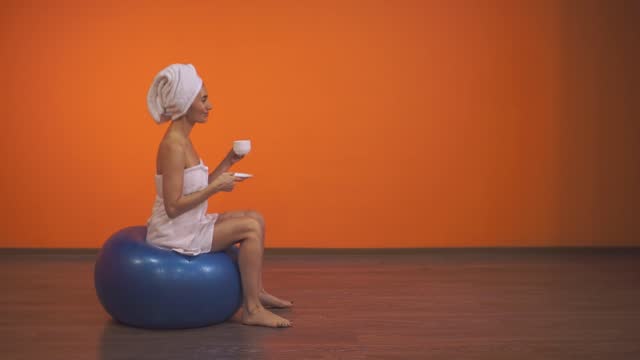 woman sitting on fitness ball