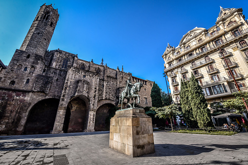Sunny Day Above Ramon Berenguer III Statue Near Roman Wall And Santa Agata Chapel in Barcelona, Spain