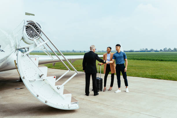 istock Pilot greets couple before boarding the luxury mid size private jet 1485177341