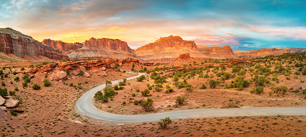 Winding dirt road in Capitol Reef National Park Utah USA at Sunset Point during sunset.
