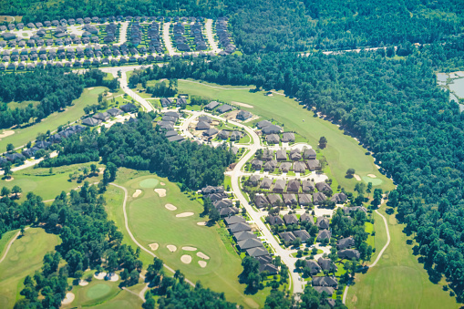 Aerial view of a suburb with golf course near Houston Texas USA.