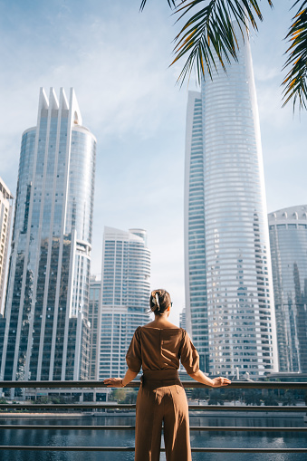 Woman walking in the modern city. City lifestyle concept.