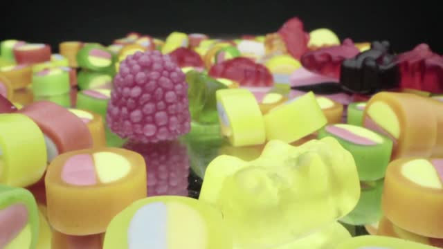 Sugared gummy candies with a variation of multicolored sour candies stock video