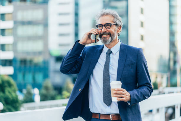 istock Elegant mature man talking on the phone 1485184330