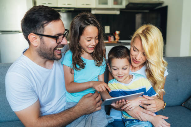 istock Young family relaxing at home with digital tablet 1485184336