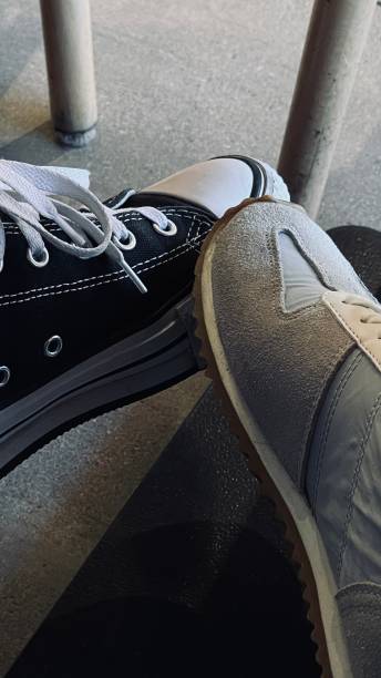 istock legs in sneakers and sneakers under the table 1485184841
