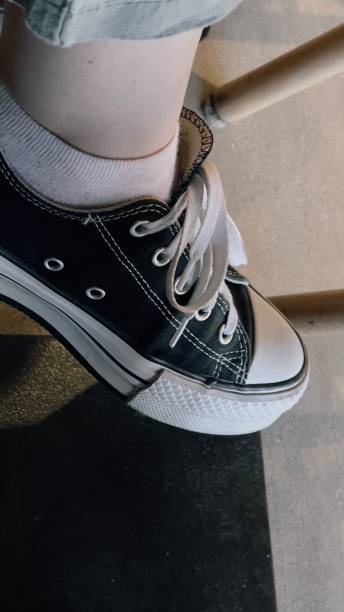 istock legs in sneakers and sneakers under the table 1485185508