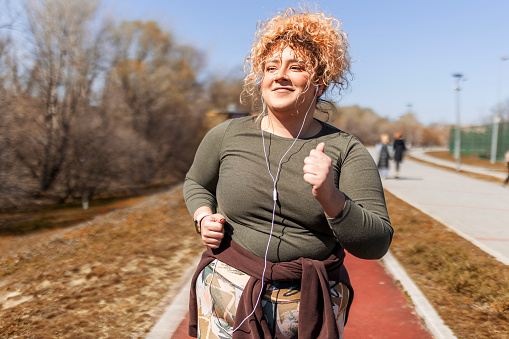 Woman with curly hair running