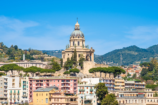 Panoramic view of Messina. Votive Temple of Christ the King or Tempio di Cristo Re on hill over town as memorial to Italian soldiers. Sicily island, Italy.